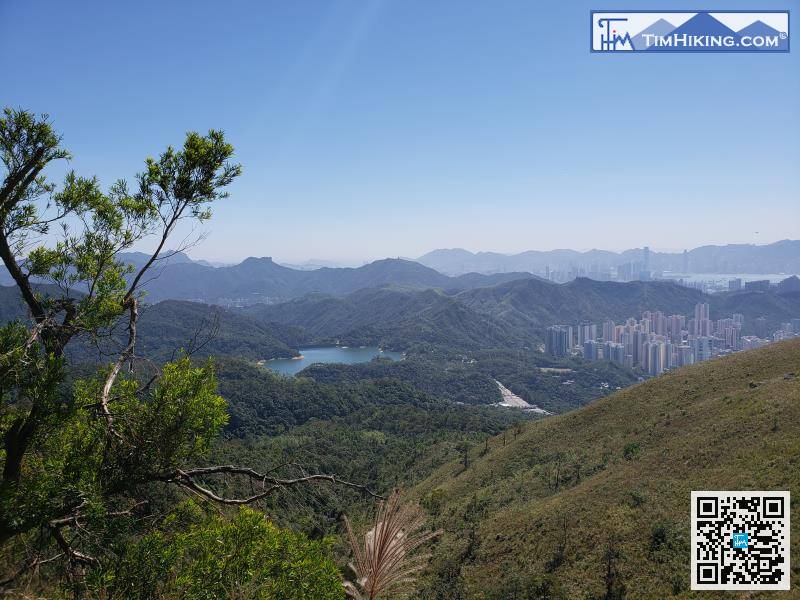 The Shing Mun Reservoir just in front in two steps.